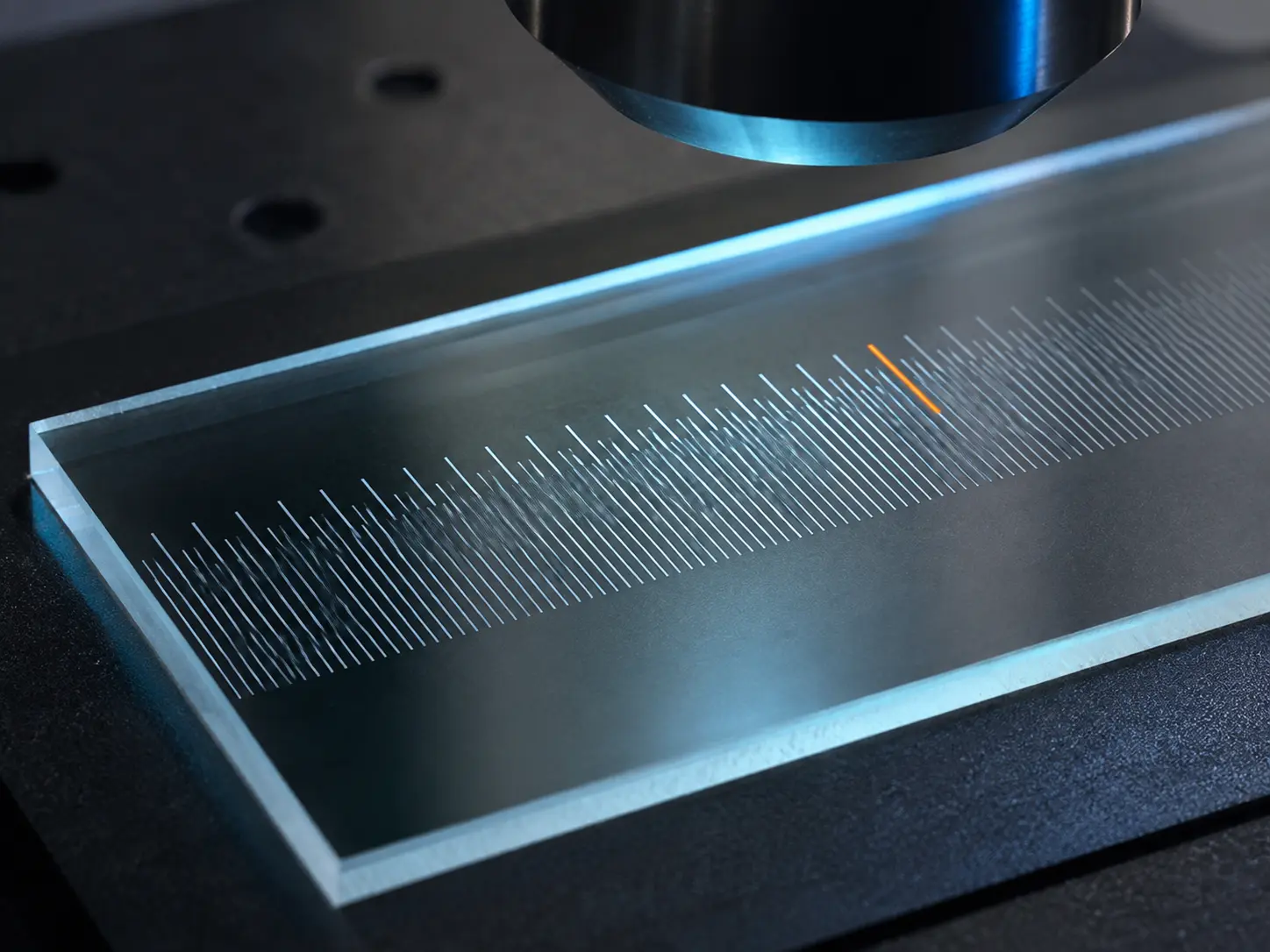 Glass calibration slide with a fine etched scale under an optical instrument